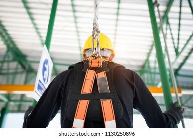 Construction Worker Wearing Safety Harness And Safety Line Working At High Place