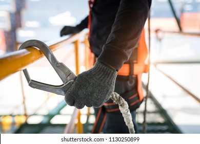 Construction worker wearing safety harness and safety line working at high place - Shutterstock ID 1130250899