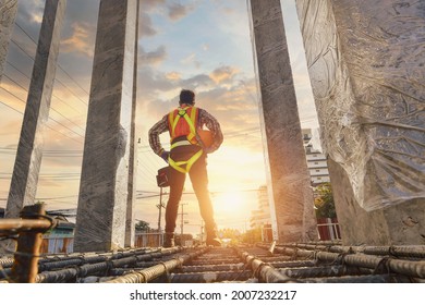 Construction worker wearing safety work at high uniform on scaffolding at construction site on during sunset,Working at height equipment. - Shutterstock ID 2007232217