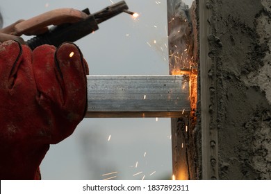 Construction Worker : Welding Of Steel On The Cement Wall Of Angle Iron Rod. With Sparks Coming Out Of Welding