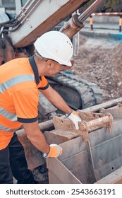 Construction worker working on a public city road reconstruction.
