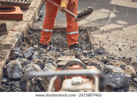 Construction worker working on a public city road reconstruction.