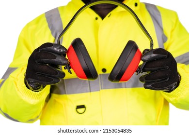  Construction Worker In Yellow Hi-viz Coat On White Background Gives Foam-filled Padded Ear Defenders To The Viewer. Wear Hearing Protection In Noisy Environment To Protect Your Hearing Safety Post