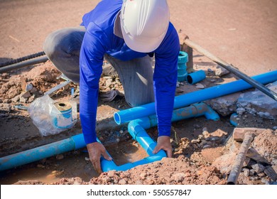 Construction Worker,Repairing A Broken Water Pipe On The Concrete Road.
