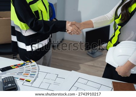 Construction workers, architects and engineers shake hands while working for teamwork and cooperation after completing an agreement in an office facility, successful cooperation concept.	
