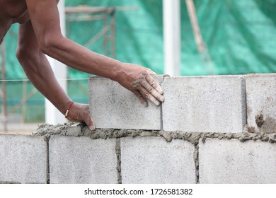 Construction workers are building brick walls. - Shutterstock ID 1726581382