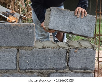 Construction Workers Are Building Cement Walls With Brick Blocks.