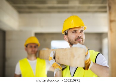 Construction Workers Collaborating On New House Building