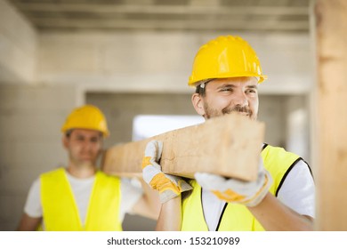 Construction Workers Collaborating On New House Building