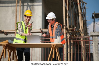 Construction workers communicate and analyze project data on-site.