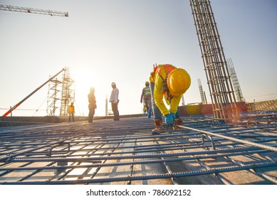 Construction workers fabricating steel reinforcement bar at the construction site