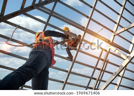 Construction workers install new roofs, roofing tools and fall protection devices. Apply to new roofRoof repair, a Specialist in Roof Forming, is the Replacement of roof plates 
