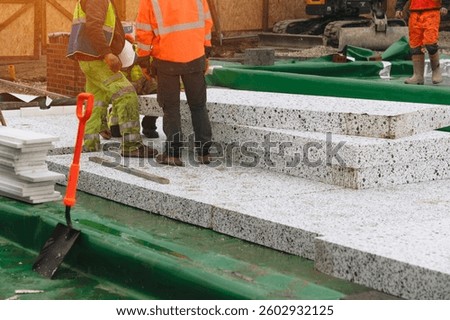 Construction workers installing Insulation polystyrene