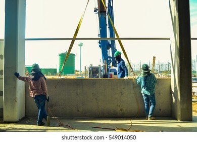 Construction workers installing the wall building.