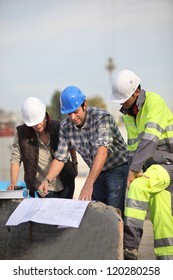 Construction Workers Looking At Site Plans