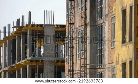 Construction workers on the floors of a skyscraper building. Men buliding a new high floor business center.