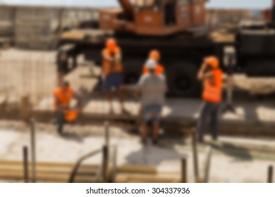 Construction, Construction Workers On Site. Blurred Background