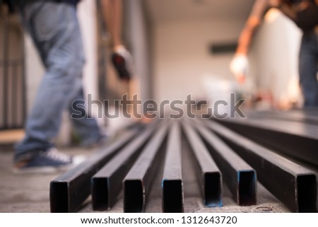 Construction workers are painting rust on the steel. Soft focus for background