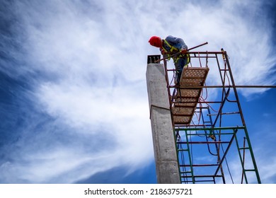 Construction Workers Put On Safety Gear To Work On The Way To Install The Factory Roof Welding Structure.