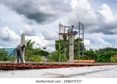 Construction Workers Put On Safety Gear To Work On The Way To Install The Factory Roof Welding Structure.