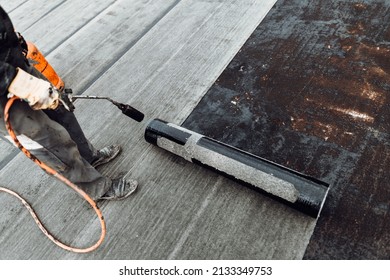 Construction Workers, Roofers Installing Rolls Of Bituminous Waterproofing Membrane