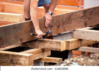 Construction Workers At The Construction Site Of A House. Undeclared Work And Community Care