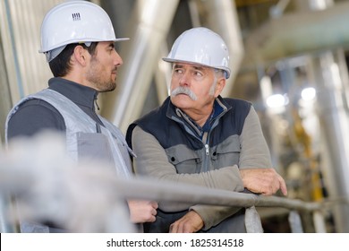 Construction Workers Talking In A Factory