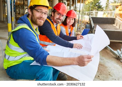 Construction workers team and architect with floor plan on the construction site when planning the work