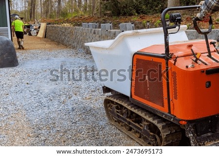 Construction workers use dumper tracked wheelbarrow when pouring concrete