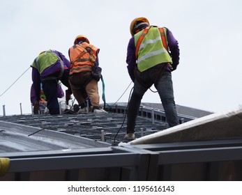 Construction Workers Wearing Ful Safety To Roofing Factory Roof