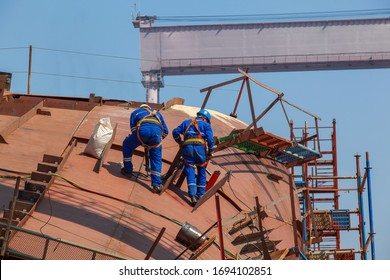 Construction Workers Wearing Safety Harness Belt During Training At High Place