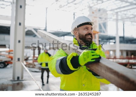 Construction workers at work on modern building site.