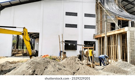 construction workers working with the help of excavators and concrete mixers