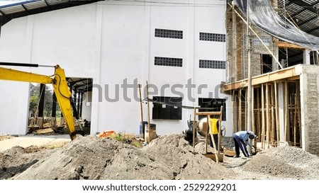 construction workers working with the help of excavators and concrete mixers