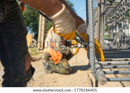 construction workers working in iron bending with pincers