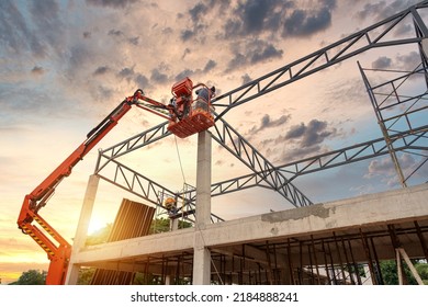 Construction workers working on Construction machine. Aerial platform for workers who work at height on buildings.  - Shutterstock ID 2184888241