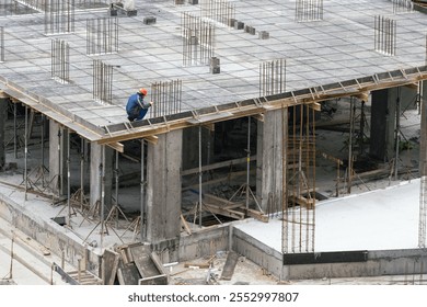 Construction workers working on Construction machine. Aerial platform for workers who work at height on buildings. 