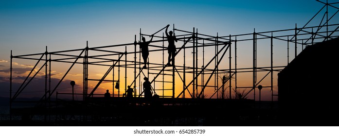 Construction workers working on scaffolding.
