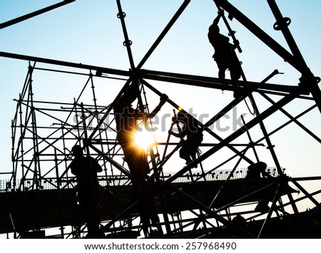 Construction workers working on scaffolding