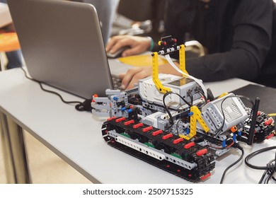 Construction workflow of electronic car with microcontroller at junior robotics club. Collective child s creation of diy electronics, modern technologies, innovation and science concept