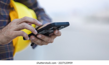 construction working touch screen smart phone at construction site - Powered by Shutterstock