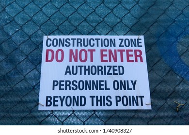 A Construction Zone Sign Warns Passerby's That The Proceeding Location Is For Authorized Personnel Only. This Sign Is Put Up To Ensure The Safety Of The Public.