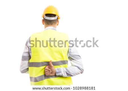 Constructor or builder showing like thumbs-up gesture behind back isolated on white studio background