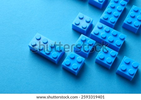 Constructor toy. Many building blocks on light blue background, above view