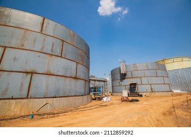 Constuction Of An Oil Derrick Crane, Big Oil Tanks On The Background.