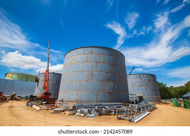 Constuction Of An Oil Derrick Crane, Big Oil Tanks On The Background.