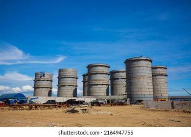 Constuction Of An Oil Derrick Crane, Big Oil Tanks On The Background.