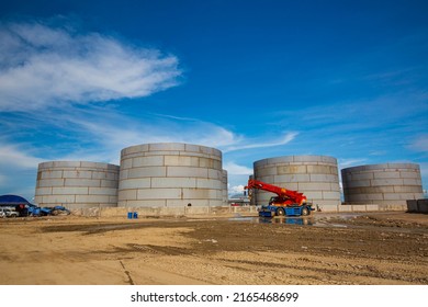 Constuction Of An Oil Derrick Crane, Big Oil Tanks On The Background.