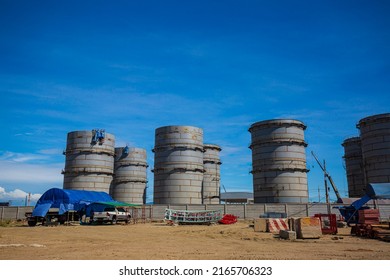 Constuction Of An Oil Derrick Crane, Big Oil Tanks On The Background.