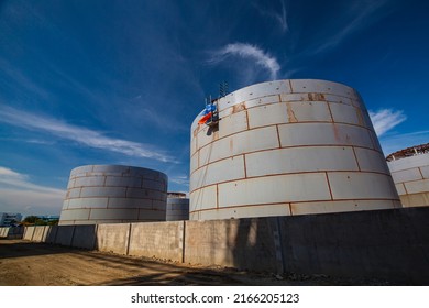 Constuction Of An Oil Derrick Crane, Big Oil Tanks On The Background.